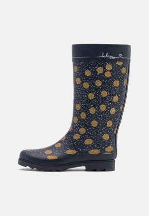 Botte de pluie bleu marine avec des pois dorés et de petites taches blanches, semelle noire et bord supérieur plié avec le texte « be happy » et un cœur.