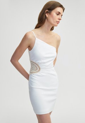 White satin dress with an asymmetrical neckline and a crochet accent at the waist, featuring a fitted silhouette and spaghetti straps.
