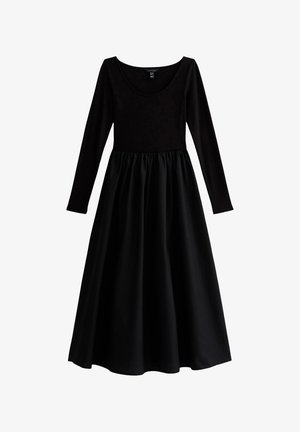 Vestido negro con un top ajustado de manga larga, escote redondeado y una falda fluida y fruncida. Hecho de una tela suave con un acabado mate.