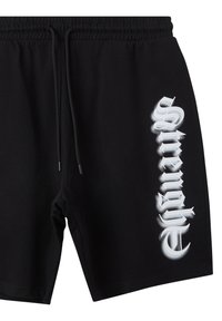 Pantaloni neri con vita elasticizzata e cordoncino. Presentano un design di testo verticale bianco, realizzati in un tessuto morbido con una texture liscia.