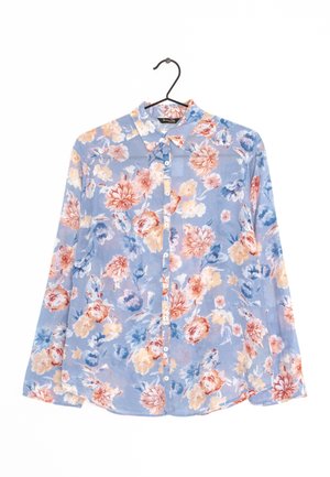 Light blue floral button-up shirt with long sleeves hanging on a black hanger against a white background.