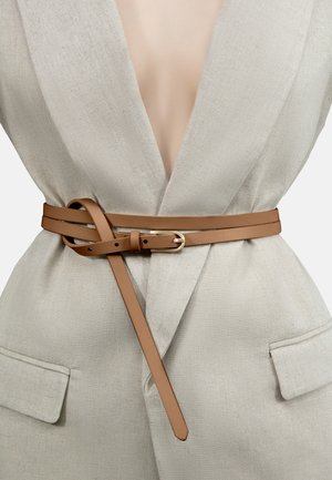 Tan leather belt with a smooth texture and a gold-tone buckle, wrapped around a light beige linen blazer featuring pockets.