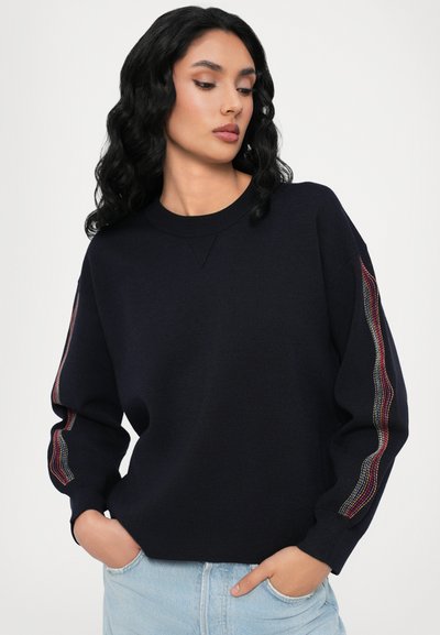 Navy knitted sweater with a crew neck, featuring multicolored stripe accents on the sleeves, relaxed fit, and ribbed cuffs.
