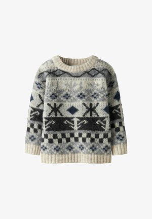 Pull en tricot avec un motif crème, gris et noir. Il possède un col rond côtelé et des manches longues, avec des motifs géométriques et de flocons de neige.