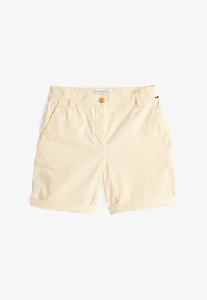 Světlé žluté bavlněné šortky s knoflíkovým zapínáním, dvěma bočními kapsami a ohrnutými lemy. Součástí je branded štítek na pase.