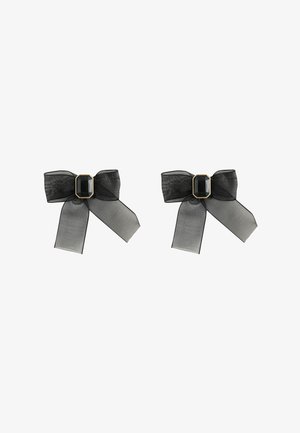 Black sheer ribbon hair bows with a central black jewel accent, featuring long trailing ends and a delicate texture.