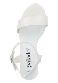 Weißer Sandale mit einem glatten Lederoberteil, breitem Vorderriemen, Knöchelriemen mit Schnalle und flacher Sohle. Mit "palado" Branding auf der Innensohle.
