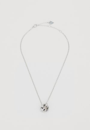 Silver necklace featuring a twisted pendant with a circular design. Pendant embellished with small gemstones and a clasp at the back.