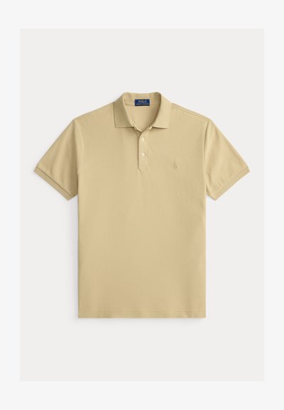 Beež lühikeste varrukatega polosärk kahe valge nööbi, soonikkoes krae ja varrukaäärtega ning vasakul rinnal peene tikitud logoga.