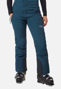 Tiefblaue Skihosen mit glatter Textur, verstellbaren Reißverschlüssen an den Taschen und verstärkten schwarzen Akzenten an den Säumen, entworfen für den Wintersport.