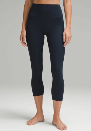 Black capri leggings with a high waistband, made of smooth, stretchy fabric. Features a fitted design and ankle-length cut.