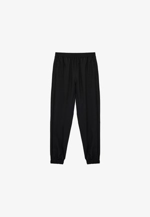 Pantalons de sport noirs avec une taille élastique, des jambes fuselées et des poignets élastiques. Fabriqués à partir d'un tissu lisse et léger.