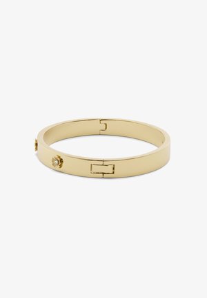 Bracelet jonc en métal doré avec une finition lisse, un fermoir articulé et deux accents décoratifs en forme de fleurs agrémentés de petites pierres précieuses.