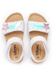 Sandales blanches avec un motif à pois, des sangles ajustables et des embellissements en forme d'étoile rose. Semelle en liège pour le confort.