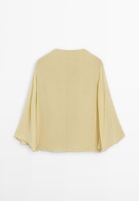 Lys gul, løs top med brede ærmer, rund halsudskæring og en glat tekstur. Minimalistisk design uden mønstre eller udsmykninger.