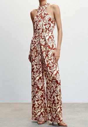 Combinaison sans manches à jambes larges avec motif floral rouille et crème, avec un col halter croisé et une ceinture nouée à la taille.