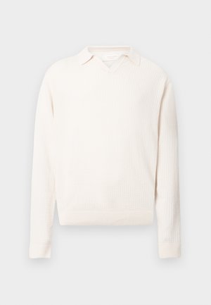 White textured sweater with a v-neck and a collar. Features ribbed cuff and hem. Made from knitted fabric.