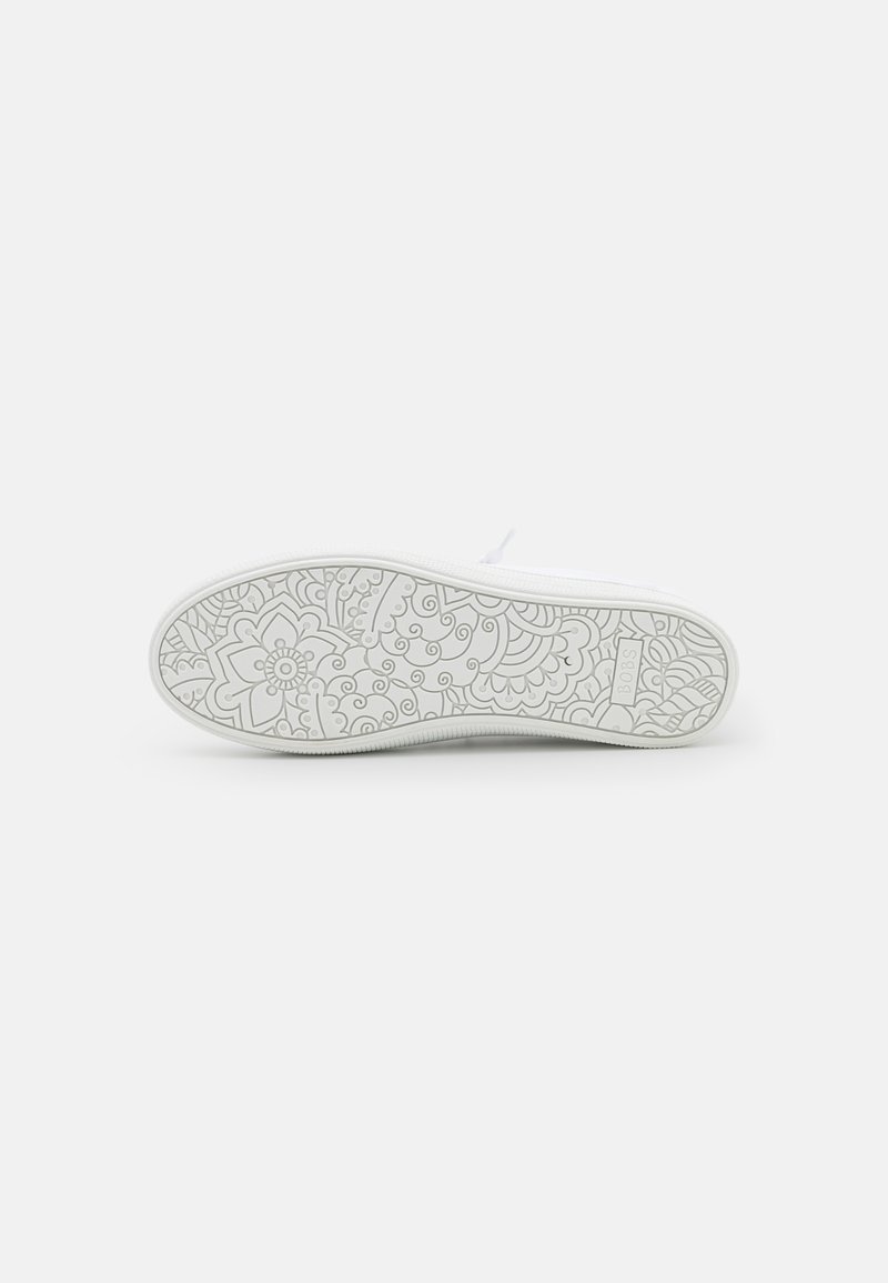 Suola di sneaker bianca con motivi floreali e swirl testurizzati. Il design presenta scanalature antiscivolo per trazione e grip.