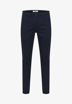 Tamsiai mėlynos kelnės, pagamintos iš medvilnės mišinio, su mygtukų uždarymu, šoninėmis kišenėmis ir elastingomis apyrankėmis kulkšnies srityje.