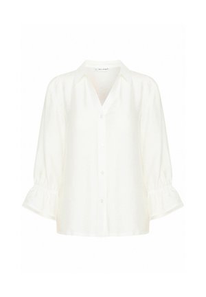 Camisa blanca de botones con cuello, mangas globo de tres cuartos y acentos texturizados en los puños. Tejido ligero.