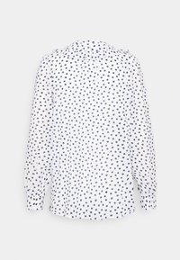 Blusa branca com bolinhas azuis marinhas, mangas longas e colarinho arredondado. Tecido leve com um acabamento ligeiramente texturizado.