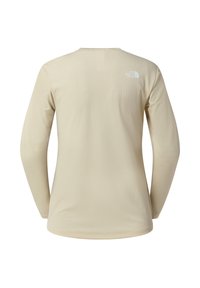 Långärmad skjorta i ljusbeige med ett strukturerat mönster. Har en rund halsringning och en liten vit logga på övre delen av ryggen.