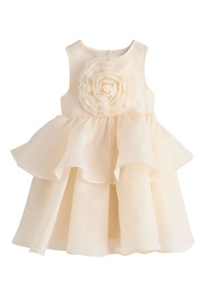 Robe sans manches couleur crème pour tout-petit avec jupe à volants et grande décoration fleur en tissu sur la poitrine.