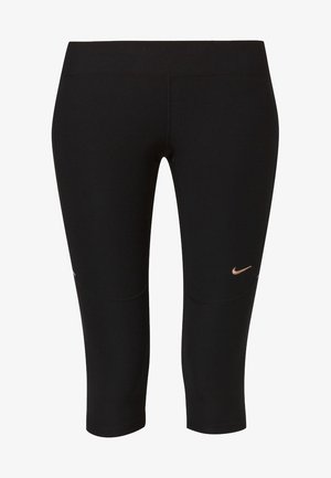Černé zkrácené legíny vyrobené z pružného materiálu s hladkou texturou. Obsahují malé růžově zlaté logo Nike na levém boku a vyztužené švy.