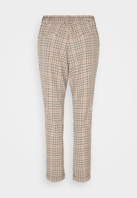 Tan rutiga byxor med elastiskt midjeband, i slim fit och med två bakfickor. Mönstret består av små bruna, svarta och krämfärgade rutor.