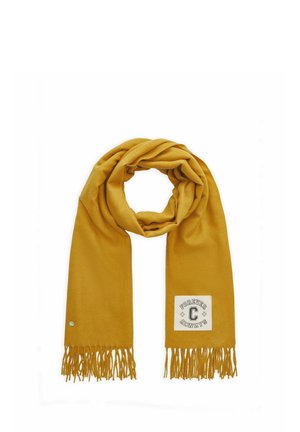 Écharpe jaune moutarde avec des extrémités à franges et un patch blanc indiquant "Forever Always C" sur un côté.