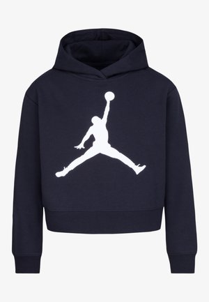 Navy zilā krāsā apgriezta kapuce, izgatavota no kokvilnas ar mīkstu tekstūru. Priekšpusē ir izteiksmīgs balts Jumpman logos. Garas piedurknes ar ribotām aprocēm.
