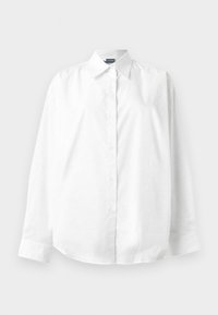 Chemise blanche à manches longues avec col et boutons, présentée sur un fond clair uni.