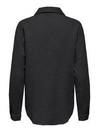 Chemise noire à manches longues en tissu texturé, avec poignets boutonnés et col classique, vue de dos sur fond blanc.