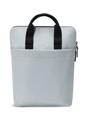 Light grey rectangular bag with front pocket, black fabric handles, and zipper closure on the right side, standing upright.