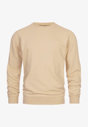 Jasno beżowy sweatshirt wykonany z bawełny. Posiada okrągły dekolt, długie rękawy oraz prążkowane mankiety i dół. Dyskretne logo na piersi.