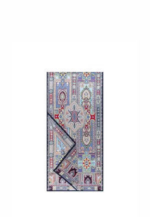Multicolored rectangular rug with intricate floral and geometric patterns in blue, red, yellow, and white, with one corner folded.