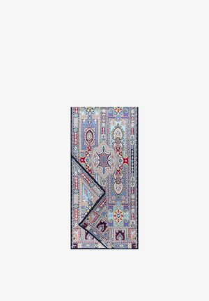 Multicolored rectangular rug with intricate floral and geometric patterns in blue, red, yellow, and white, with one corner folded.