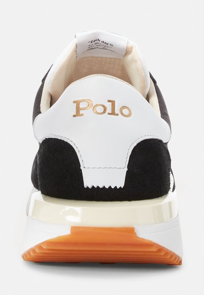 Fekete velúr sportcipő fehér bőr kiegészítőkkel és narancssárga gumi talppal. Arany "Polo" logó a sarokon. Párnázott design.
