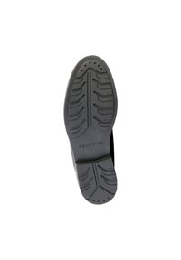 Suela de zapato de goma negra con un patrón de banda de rodadura y ranuras para tracción. La marca "REDSKINS" está grabada cerca del talón.