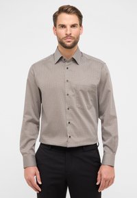 Heren overhemd met lange mouwen in bruin met een geometrisch patroon, button-down kraag en donkere knopen op een gladde stof. Tailored fit met lange mouwen.