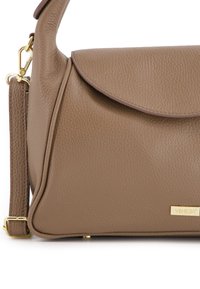 Brown textured leather handbag with a flap closure, gold hardware accents, and a detachable shoulder strap. Features a logo plate.