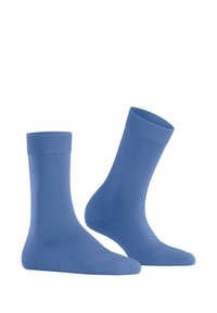 Calzini di cotone blu con una trama liscia, polsini a coste e lunghezza classica. Presentano un colore unito senza motivi né accessori.