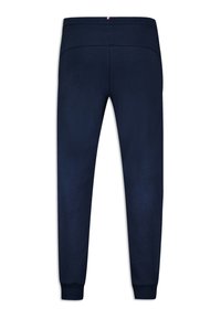Navyblauwe trainingsbroek van zacht materiaal, met elastische tailleband en boorden. Voorzien van een subtiele logoaccent op de tailleband.
