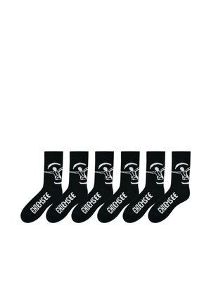 Six pairs of black crew socks with white text "CHIEMSEE" and a white graphic of a person holding a rope across the ankle area.