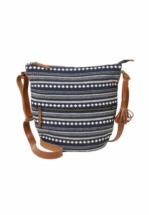 Navy and white patterned fabric shoulder bag with brown leather strap and tassel, zippered front pocket, and top zipper closure.