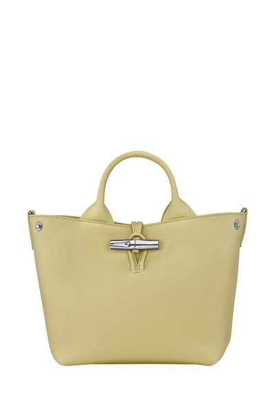 Yellow leather handbag with textured surface, dual handles, and a silver hardware fastening. Features a structured shape and minimalist design.