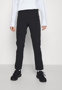 Czarne spodnie outdoorowe wykonane z elastycznej tkaniny, z zamykanymi kieszeniami bocznymi, zwężanym krojem i wzmocnionymi miejscami na kolanach dla większej trwałości.