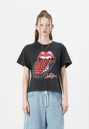T-shirt en coton noir avec un logo Rolling Stones rouge et blanc audacieux représentant une bouche avec une langue, à manches courtes et coupe décontractée.