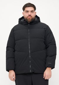 Black puffer jacket with a zip front, hood, and ribbed texture. Features horizontal panels and a discreet logo on the sleeve.