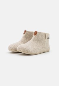 Beige felt slippers with a low ankle design, featuring brown leather accents at the openings and a beige rubber sole.
